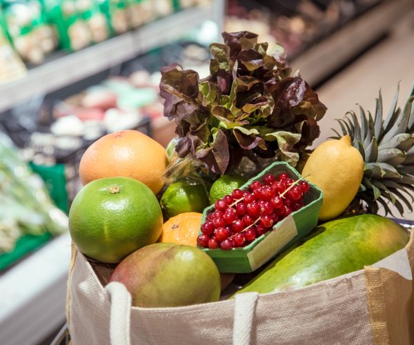 Eco bag with different fruits and vegetables. Shopping at the supermarket . Healthy food .